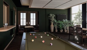 Une table de billard avec des billes, un bar et des sièges.