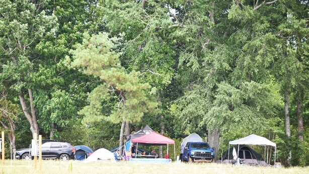 A campsite with tents, a red canopy, and a blue truck. - Walk to Rock The South Tent/Car Camping (Cullman)