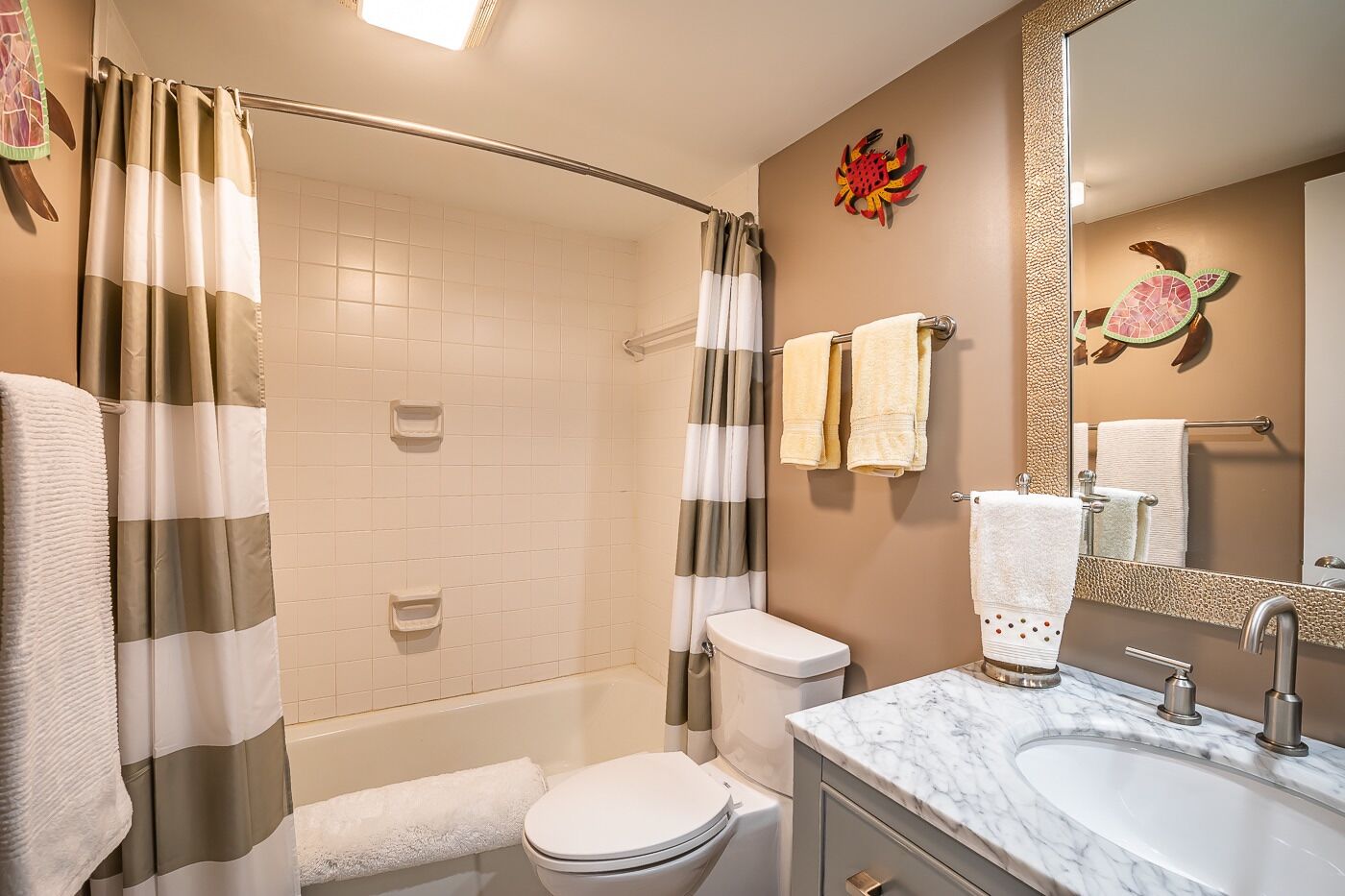 A bathroom with a shower, toilet, and sink.