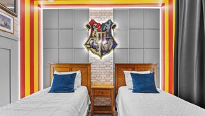 A room with two beds, a wooden nightstand, and a wall-mounted emblem. - 4BR house with pool near Disney area (Kissimmee)