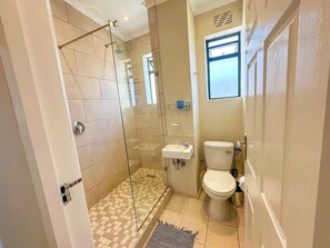 Shower, hair dryer, towels, soap