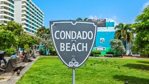 A sign for Condado Beach with a clear view of the beach and surrounding buildings. - Deluxe Ocean View Studio with Free Parking & Pool (San Juan)