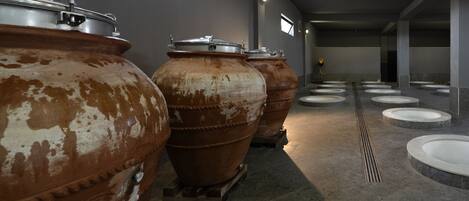 A corridor with large industrial tanks and multiple sinks.