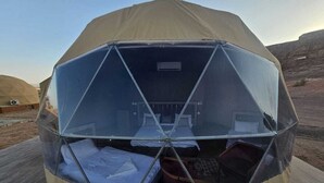 A geodesic dome tent with a central sleeping area and a small kitchenette. - Wadi Rum Desert Camp (Wadi Rum)