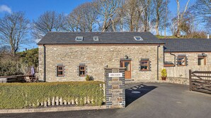 A stone building with a sign reading 'HELYGEN.' - Cottage on Cardigan Bay With Hot Tub (Talybont)