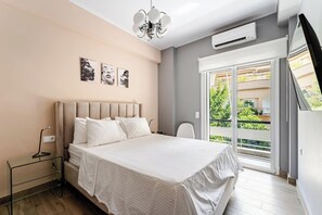 A bedroom with a bed, bedside table, and a view of the outdoors. - Luxury Serenity-Cozy Stay by the Sea and Marina (Pireas)