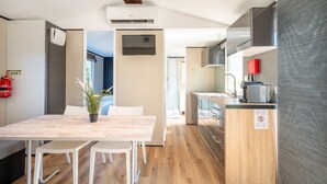 A modern kitchen with a built-in oven, a coffee machine, and a sink.