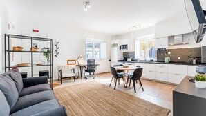 A modern apartment with a living room, dining area, and kitchen. - Modern Retreat in Castro Marim by LovelyStay (Castro Marim)
