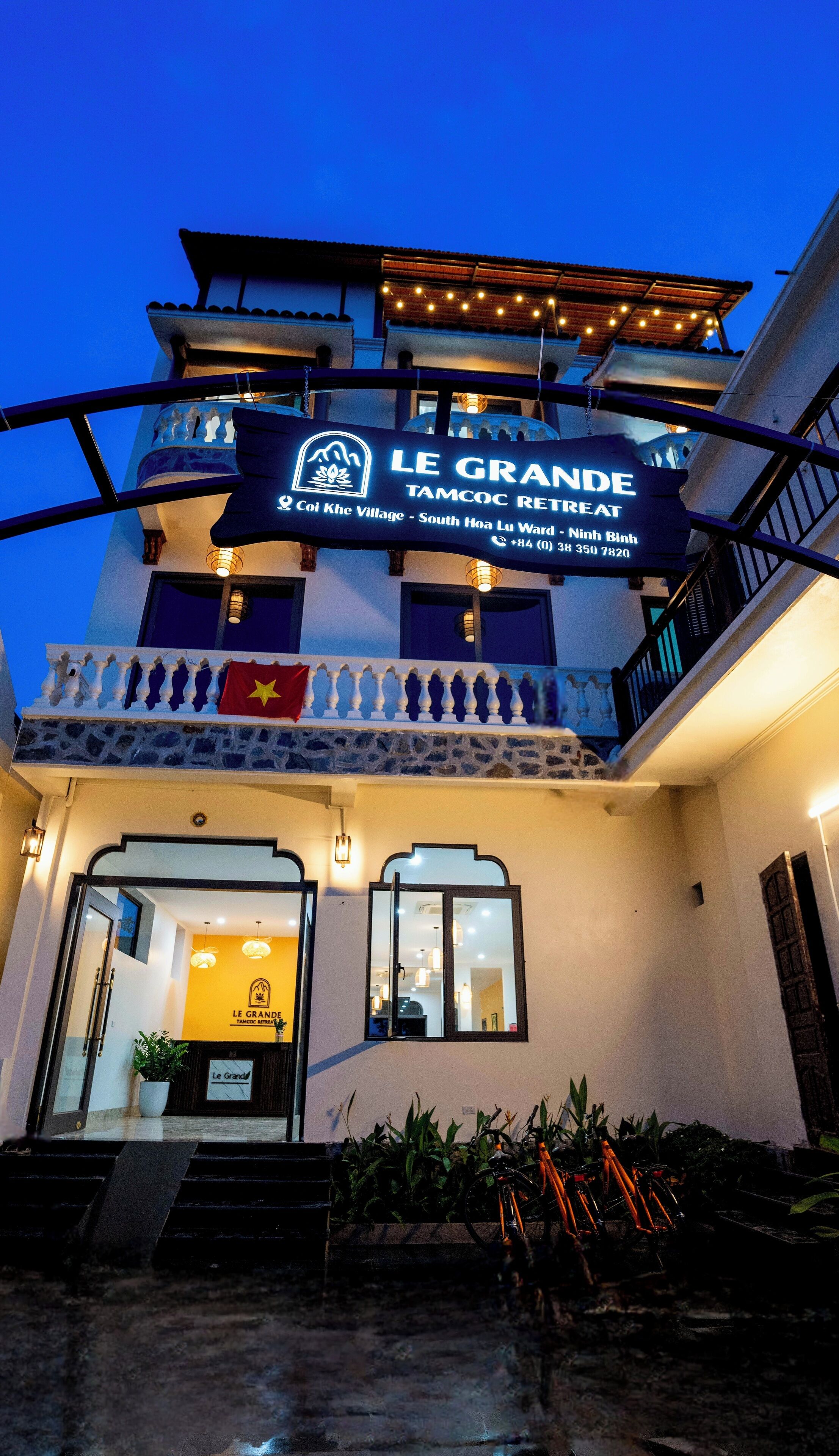A building with a sign reading 'Le Grande Tamoc Retreat' and a flag.