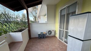 A balcony with a tiled floor, a white refrigerator, and two air conditioning units. - Welcoming and well-kept, it is the perfect base for discovering the wonders of Salento. (Lizzanello)