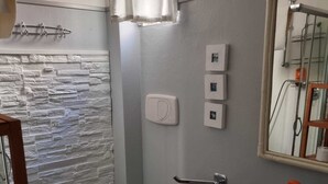 A bathroom with a toilet, bidet, and sink.