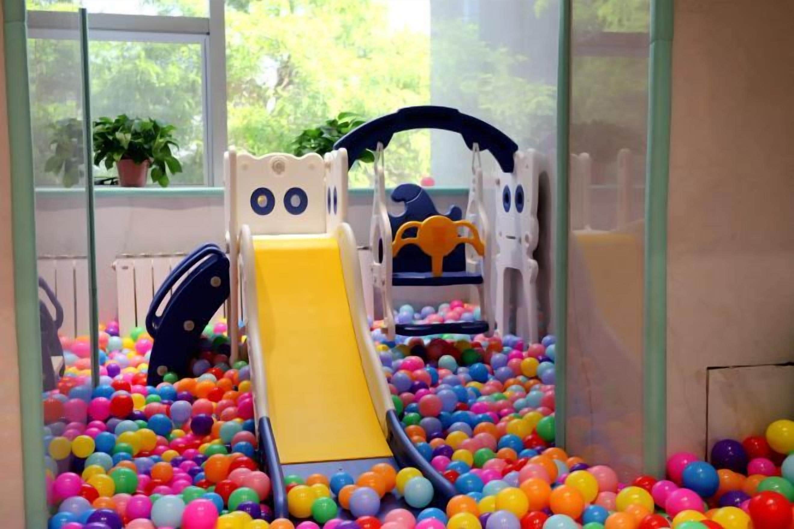 A play area with a slide and ball pit.