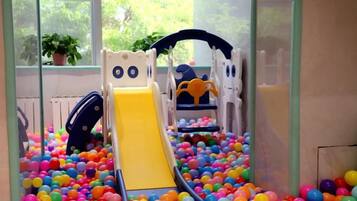A play area with a slide and ball pit.