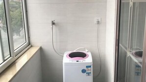A compact room with a window, a water heater, and a door. - Jinlu Business Hotel (Shanghai)