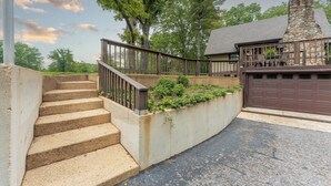 A residential property with a stone staircase, a wooden deck, and a garage. - Rustic charm with modern amenities, ensuring a comfortable and memorable stay. (Mountain View)