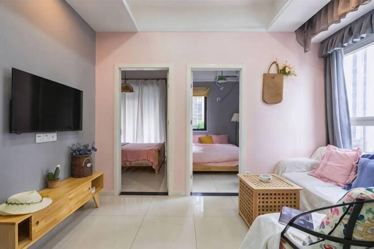 A room with a bed, a TV, a desk, and a window.
