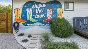 A building with a mural featuring boots and the text 'share the love.'