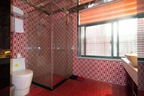 A bathroom with a shower, toilet, and sink, featuring a red and white patterned tile wall and floor. - fengyuhotel (Shanghai)