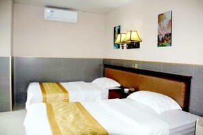 A hotel room with two beds, a headboard, an air conditioning unit, a wall-mounted lamp, and two framed artworks. - Hanlin Business Hotel (Huaibei)