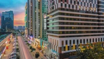 A multi-story building with a modern architectural design, featuring a prominent entrance and a series of windows.