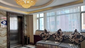 A lobby with a marble floor, a sofa with patterned cushions, a chandelier, and a large window with sheer curtains. - Kuqa Haodu Business Hotel (Kuqa)