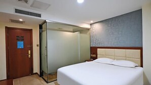 A hotel room with a bed, a door, a glass partition, and a patterned wall. - Super 8 Hotel (Beijing Jianguomen Subway Station Capital Children's Research Institute) (Beijing)