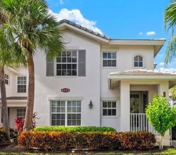 Front exterior w/new cream and taupe Mediterranean inspired architecture.2nd fl