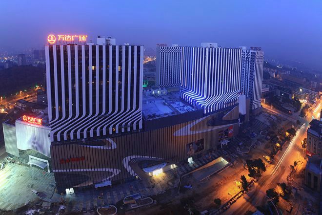 A multi-story hotel with a distinctive curved facade and a prominent vertical stripe pattern.