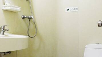 A bathroom with a sink, a shower, and a toilet.