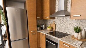 A modern kitchen with wooden cabinets, a stainless steel refrigerator, an oven, and a microwave. - Láttic, Terres de lébre Biosphere Reserve (La Ràpita)