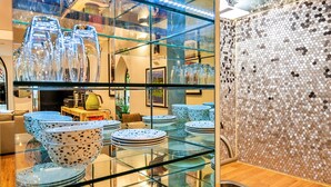 A kitchen with a glass display case, a sink, and a decorative wall. - Apartment in Matlock Near Peak District (Matlock)