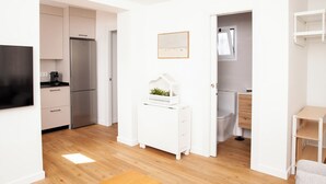 A modern, minimalist kitchen with white cabinetry, a built-in oven, and a coffee machine. - Charming relax 2 bedroom apartment 200 meter to beach and 15 min bus city center (Málaga)