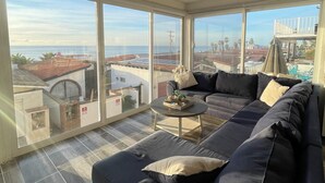 A spacious balcony with a view of the sea and buildings. - Beautiful 4 story beach house with amazing rooftop located in  Tijuana-Rosarito. (Tijuana)