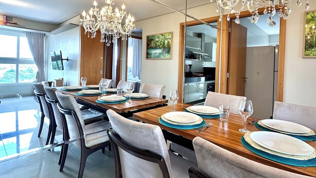 A modern dining area with a long table set for six, surrounded by chairs. - Davisis Luxo Dunas do Jalapão (Palmas)