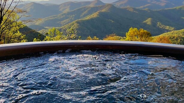 A hot tub with a view of mountains and trees. - Dual Peaks Gem $1M Sharp Views /HOT TUB & WiFi (Tuckasegee)