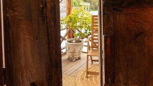 A wooden door with a 'No Smoking' sign, leading to an outdoor area with a wooden deck, chairs, and a potted plant. - Vacation 'Casa Guimar' with Sea View, Wi-Fi and Air Conditioning (Tanque)