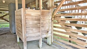 A wooden structure with a slatted roof and a concrete floor, possibly a barn or storage shed. - Short Walk To The Beach, Water Views, Screened in Porch, Sun Deck (Salvo)