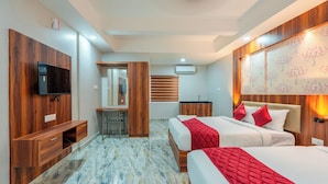 Une chambre d’hôtel moderne équipée d’un grand lit, d’un bureau, d’une télévision et d’une salle de bain.