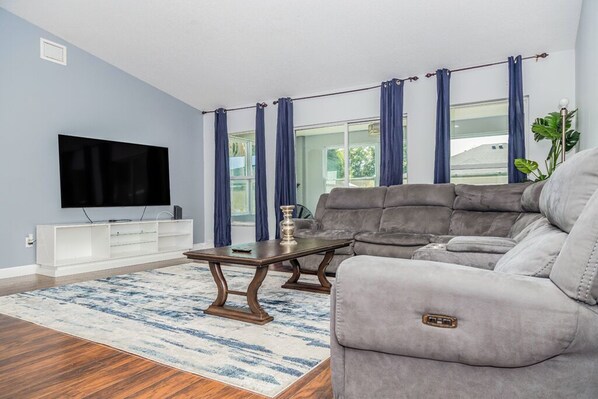 Relax in this stylish living room with a comfortable sofa, flat-screen TV, and large window.