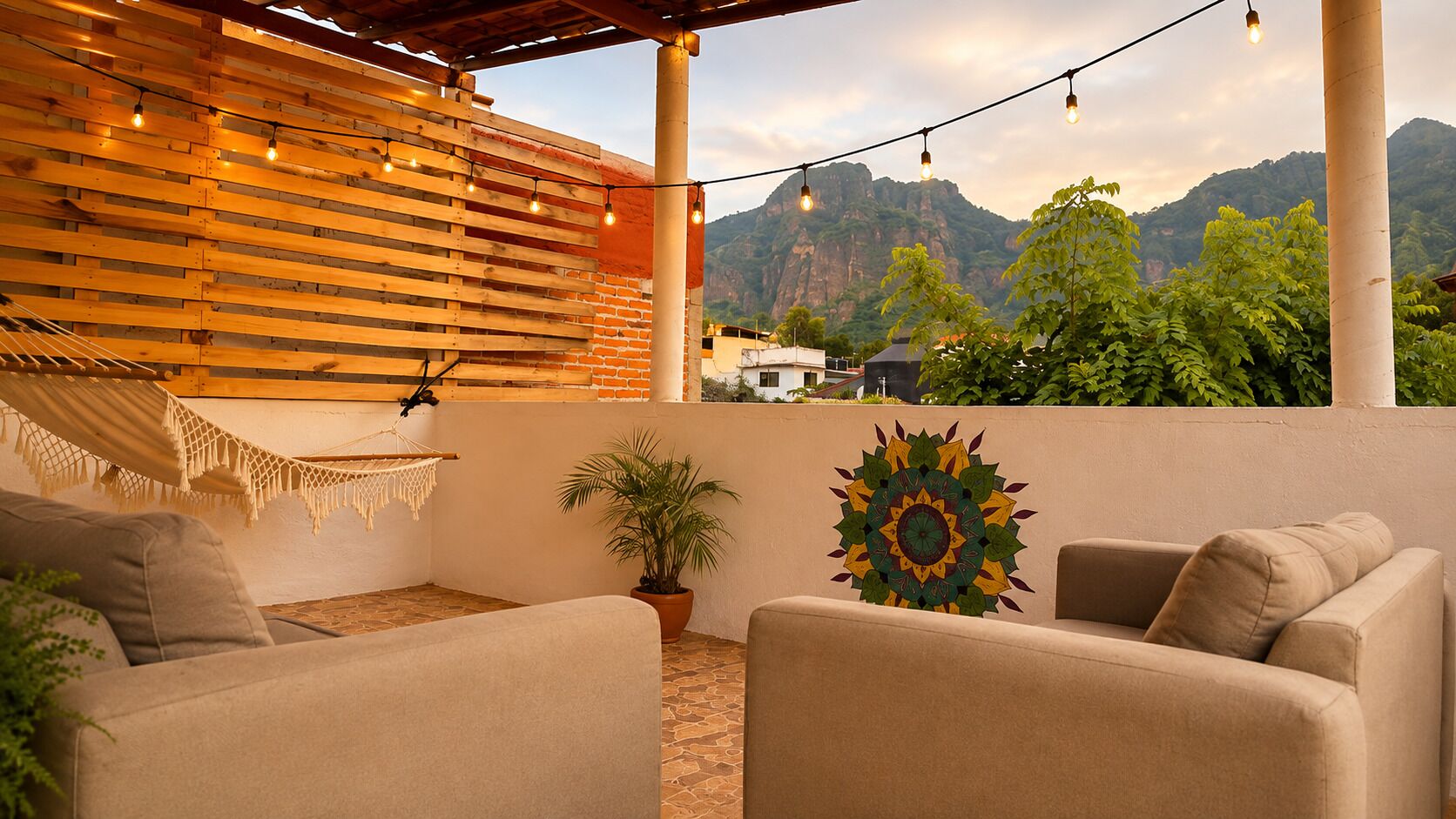 An outdoor seating area with a hammock, a potted plant, and a wall mural.