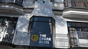 A multi-story building with balconies and a sign for "The Cedar Bliss." - The Cedar Bliss (Shimla)