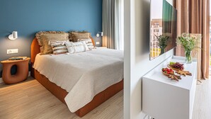 A modern bedroom with a bed, a nightstand, a TV, and a window with a view. - Perla | Coastal Comfort | Terrace with Sea View | SPA AccessPerla (Gąski)