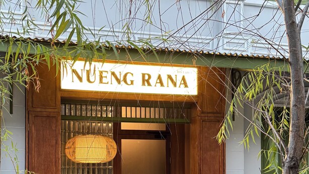 A wooden entrance with a sign reading "NUENG RANA". - Charming 3-bedroom house with AC, WiFi in marvelous Bangkok (Krung Thep Maha Nakhon)