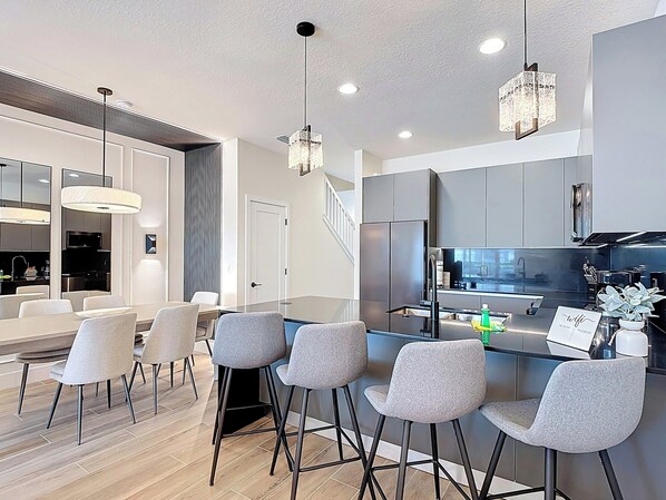 Sleek Kitchen and Dining Area with Island Breakfast Bar