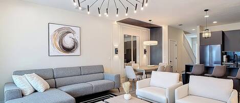 Open-concept living area with stylish seating and statement lighting