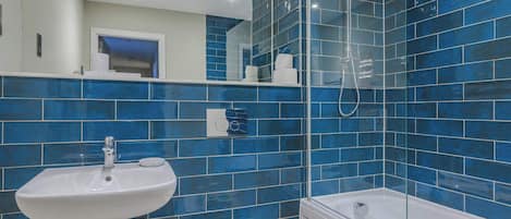 Shower, hair dryer, towels, shampoo