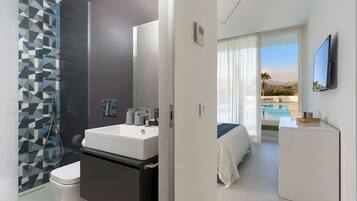 Enjoy a serene pool view from the balcony, featuring a glass shower and sleek bathroom amenities.