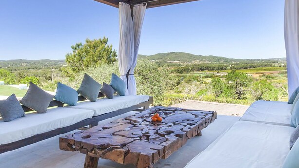 A covered outdoor seating area with a view of a hilly landscape. - Villa in Santa Eulària Des Riu with 4 bedrooms sleeps 8 (Santa Eulària Des Riu)