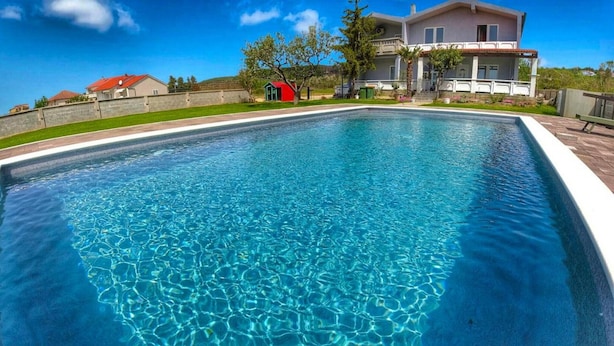 A rectangular swimming pool with clear blue water.