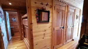A wooden interior with a hallway leading to a room with a door. - 3-room apartment for 7 people, renovated, sunny balcony (Pra-Loup)